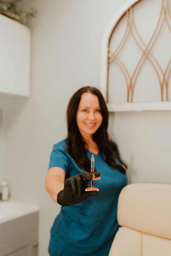 A woman is holding a syringe in her hand and smiling.