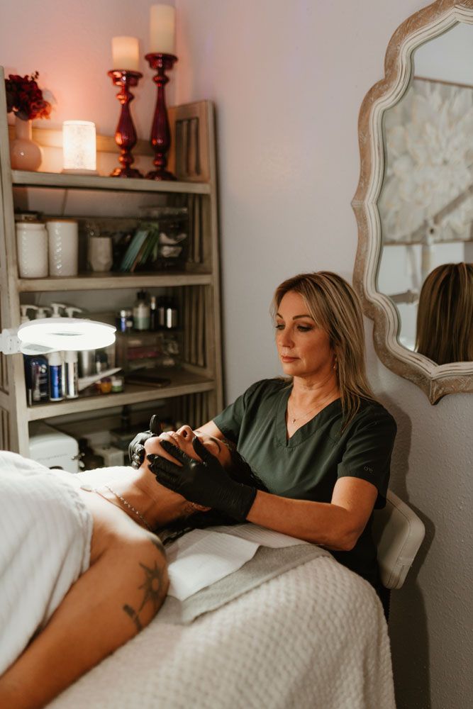 A woman is giving a woman a facial in a spa.