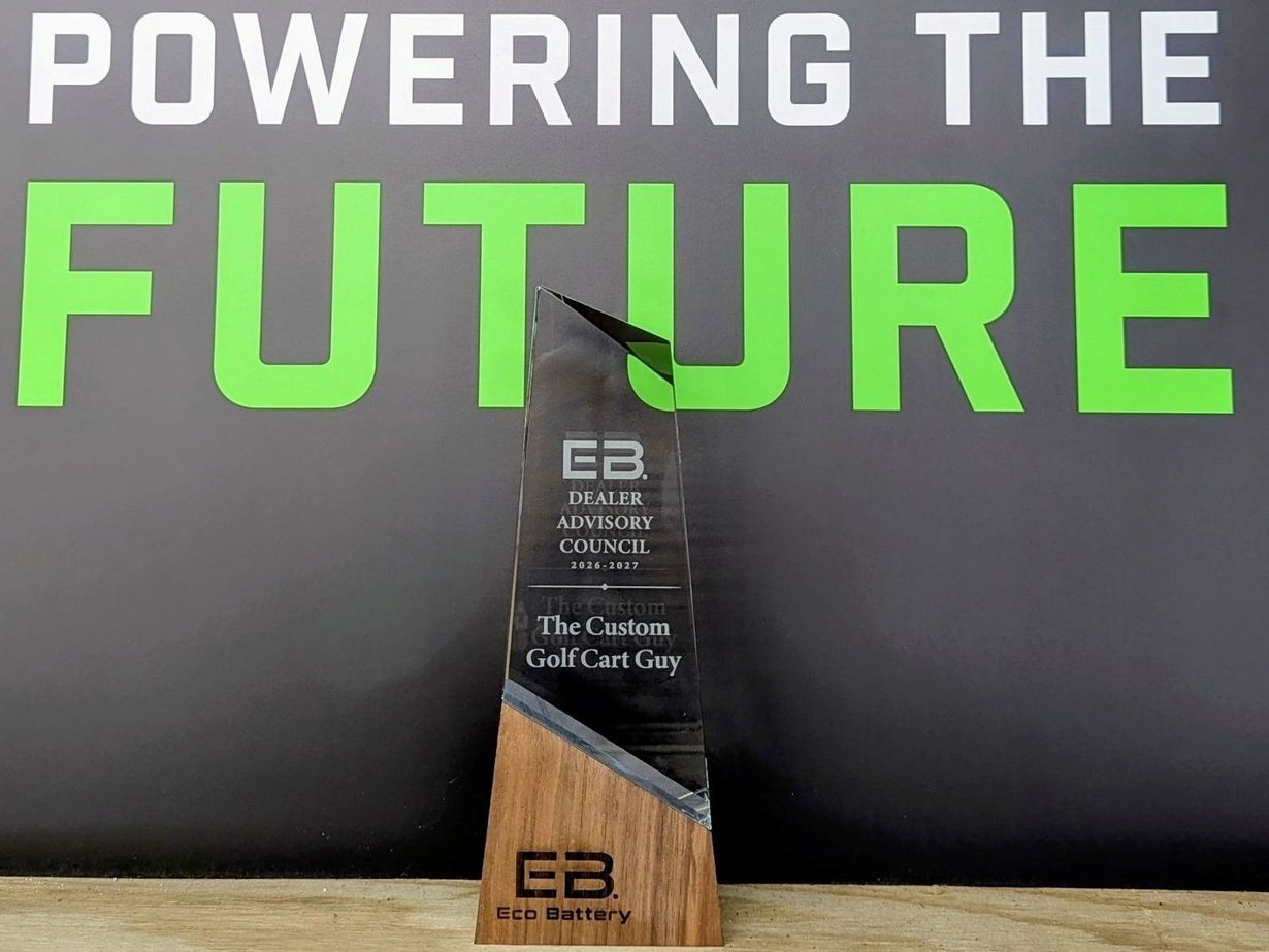 Text reading “POWERING THE FUTURE” above a black and wood trophy on a dark background