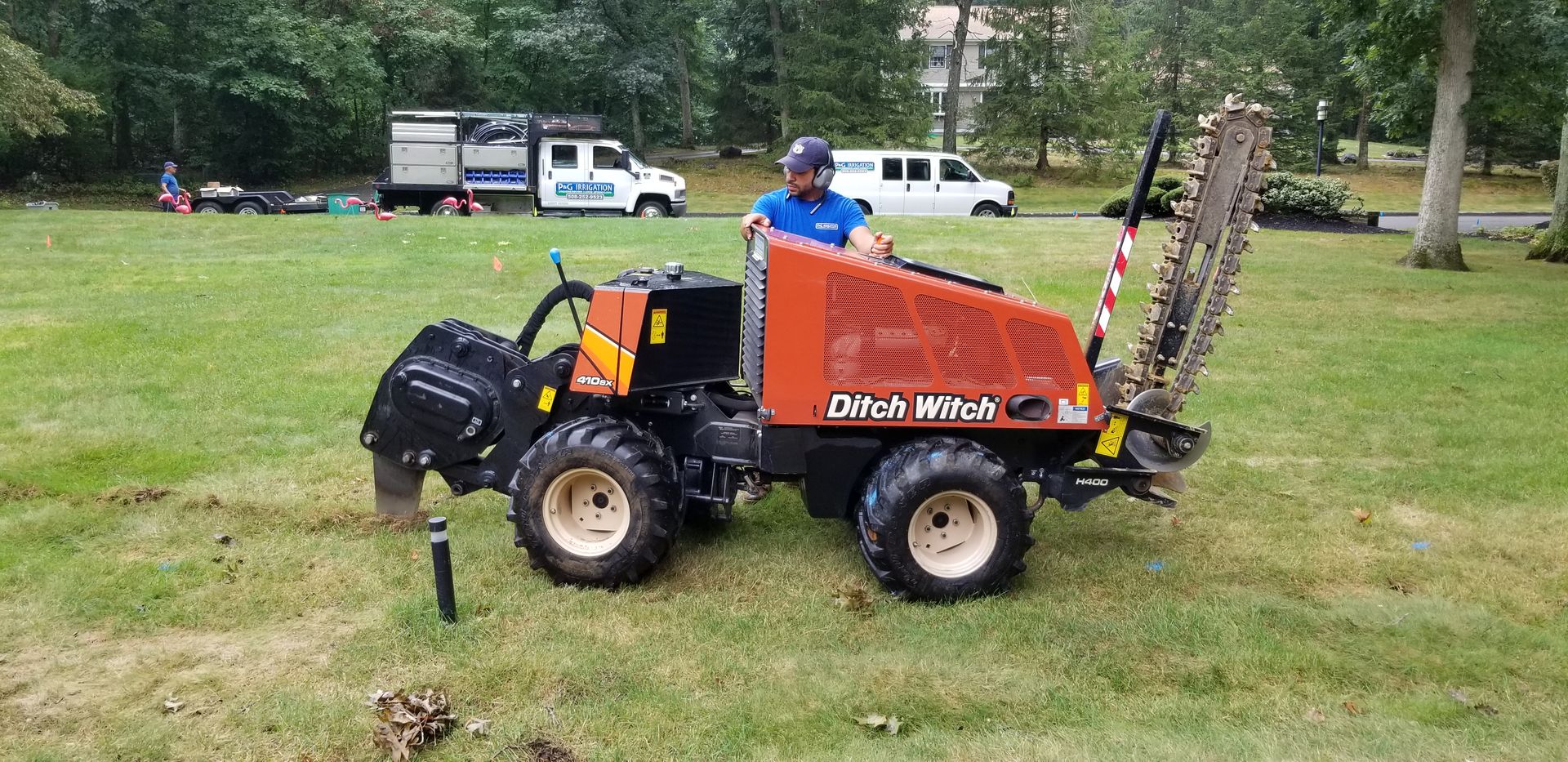 A man is driving a tractor in a grassy field.