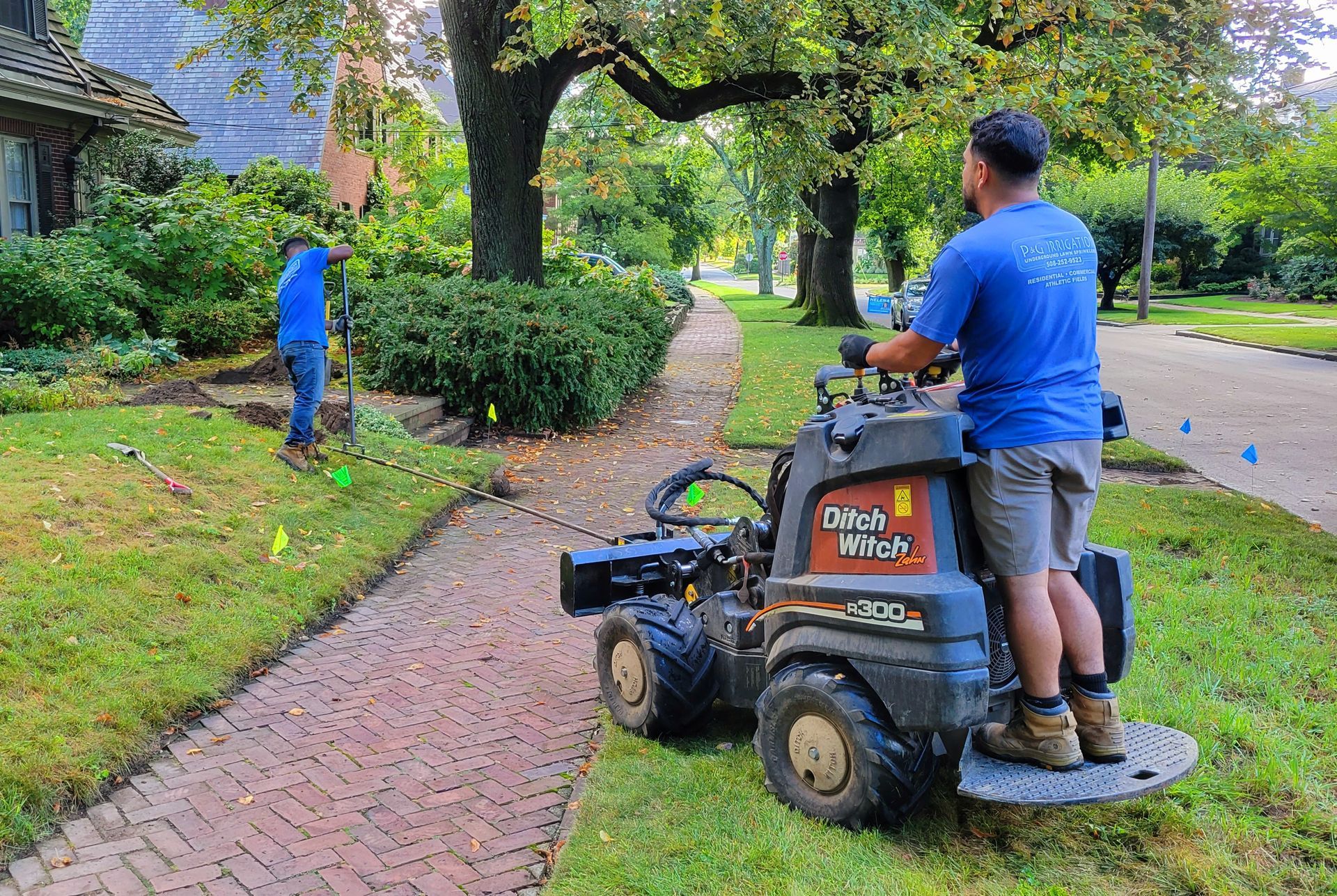 A man is riding a lawn mower down a sidewalk.