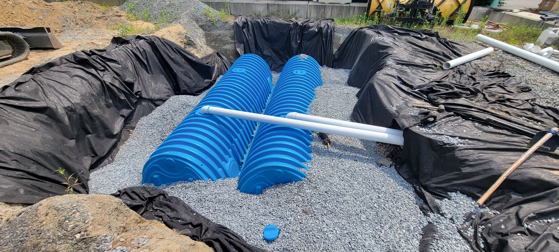 A septic system is being built in a hole in the ground.