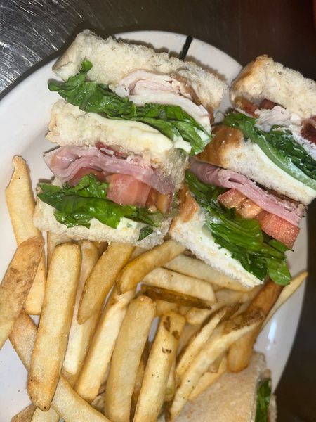 Club sandwich and fries on a plate