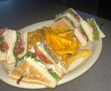 Club sandwich and potato chips on a white plate