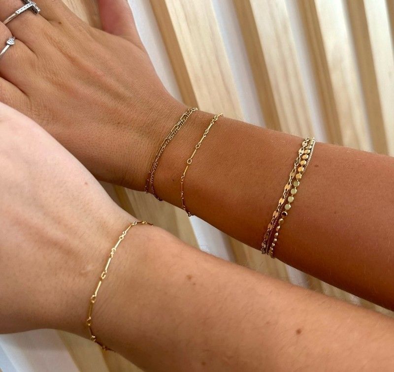 A close up of a person 's wrist with bracelets on it