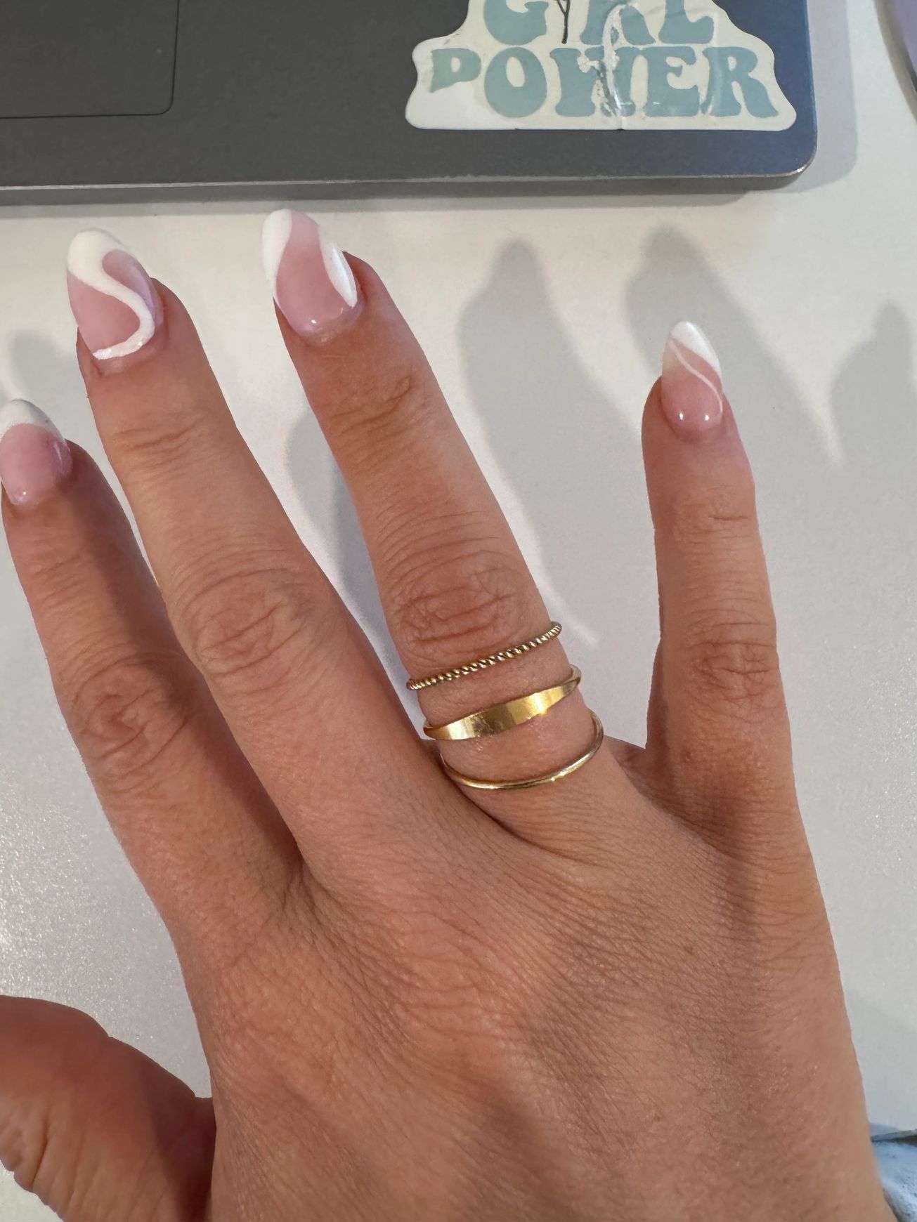 A woman 's hand with a girl power sticker on it