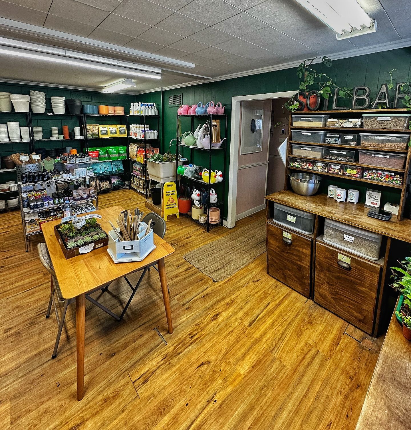 A room with a table, chairs, shelves, and boxes.