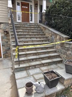 A set of stairs leading up to a house with a yellow tape around them.