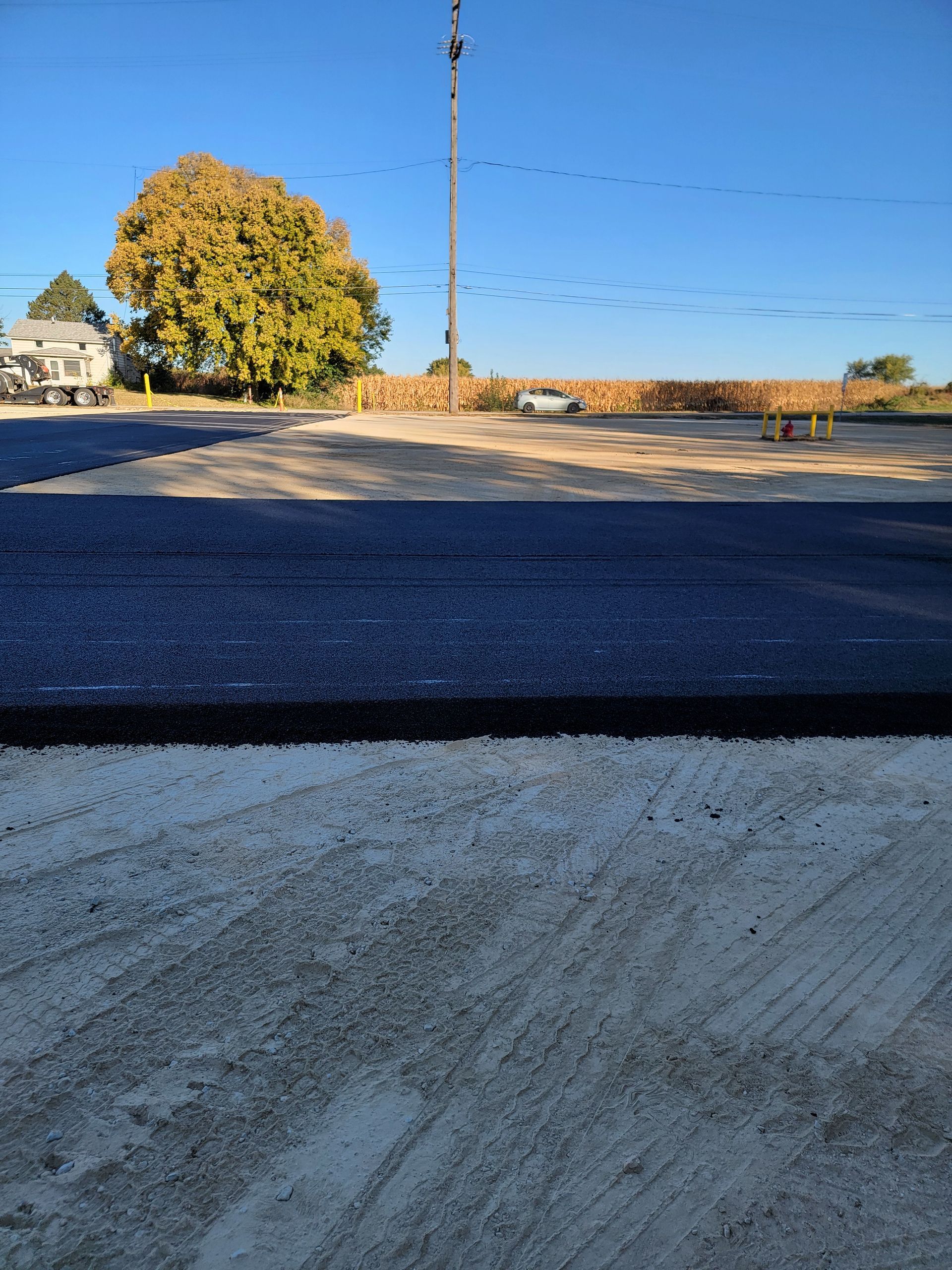 A road that is being built with a tree in the background
