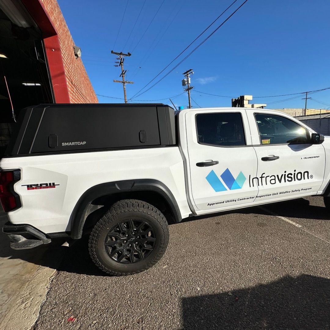 White pickup truck with black topper and 