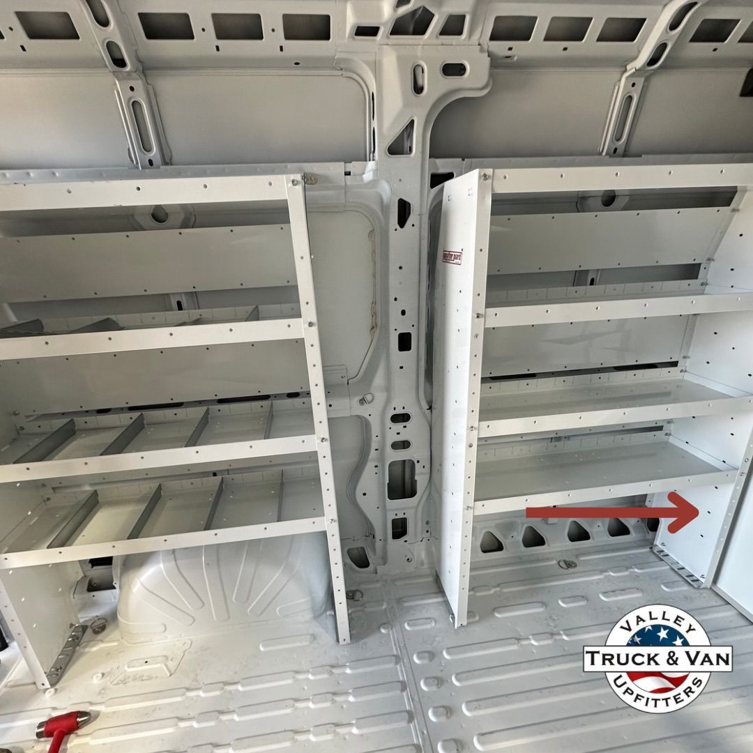 White shelving system installed in a cargo van, with shelves on both sides.