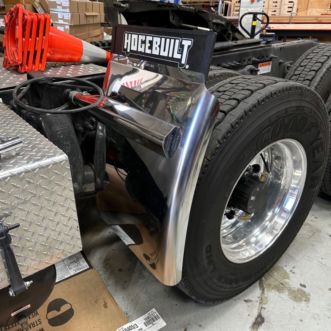 Chrome truck fender attached to a large tire. 