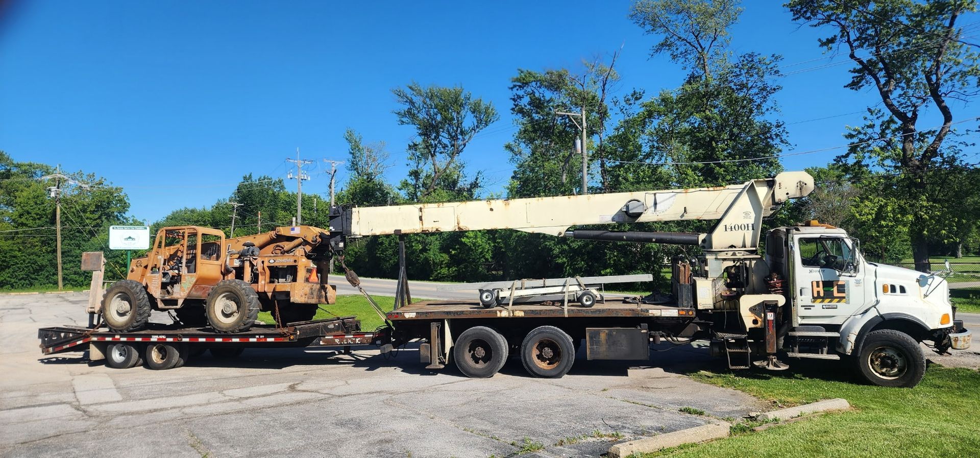 A tow truck with a crane on the back of it