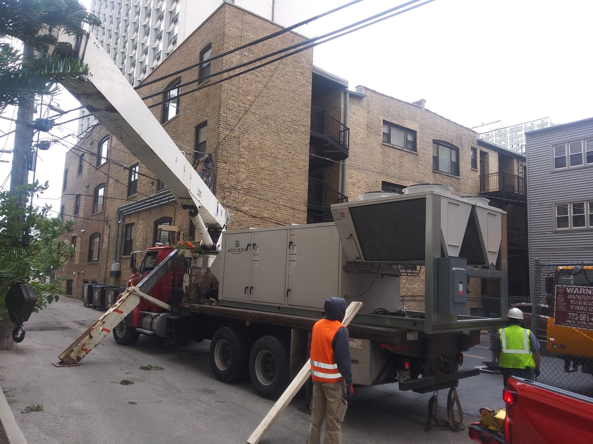 A truck is carrying a large piece of equipment on the back of it