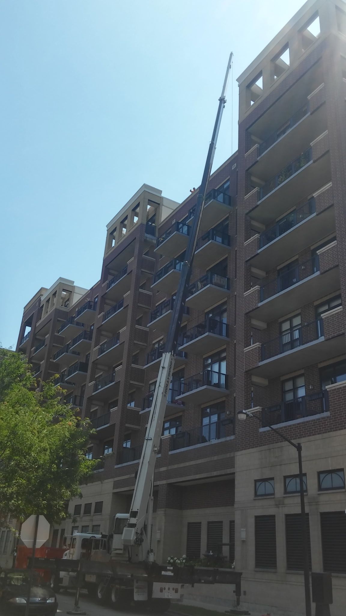 A large building with a crane in front of it.
