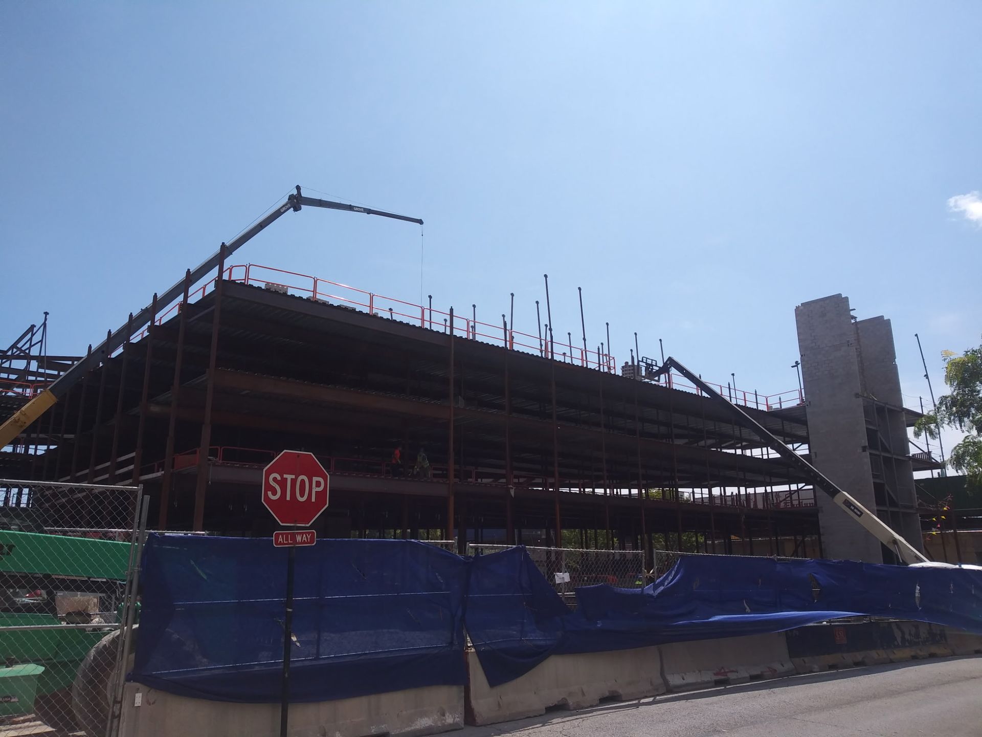 A large building under construction with a stop sign in front of it