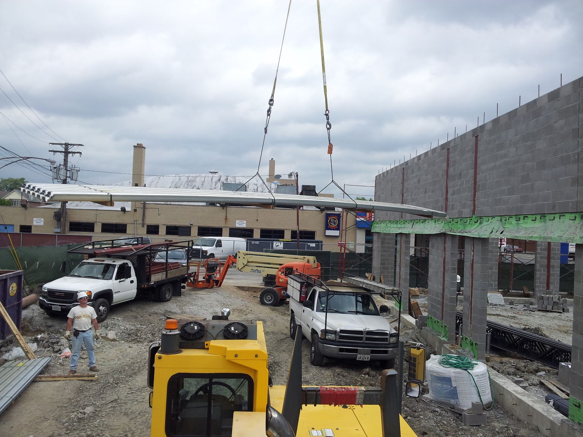 A construction site with trucks and a crane in the background