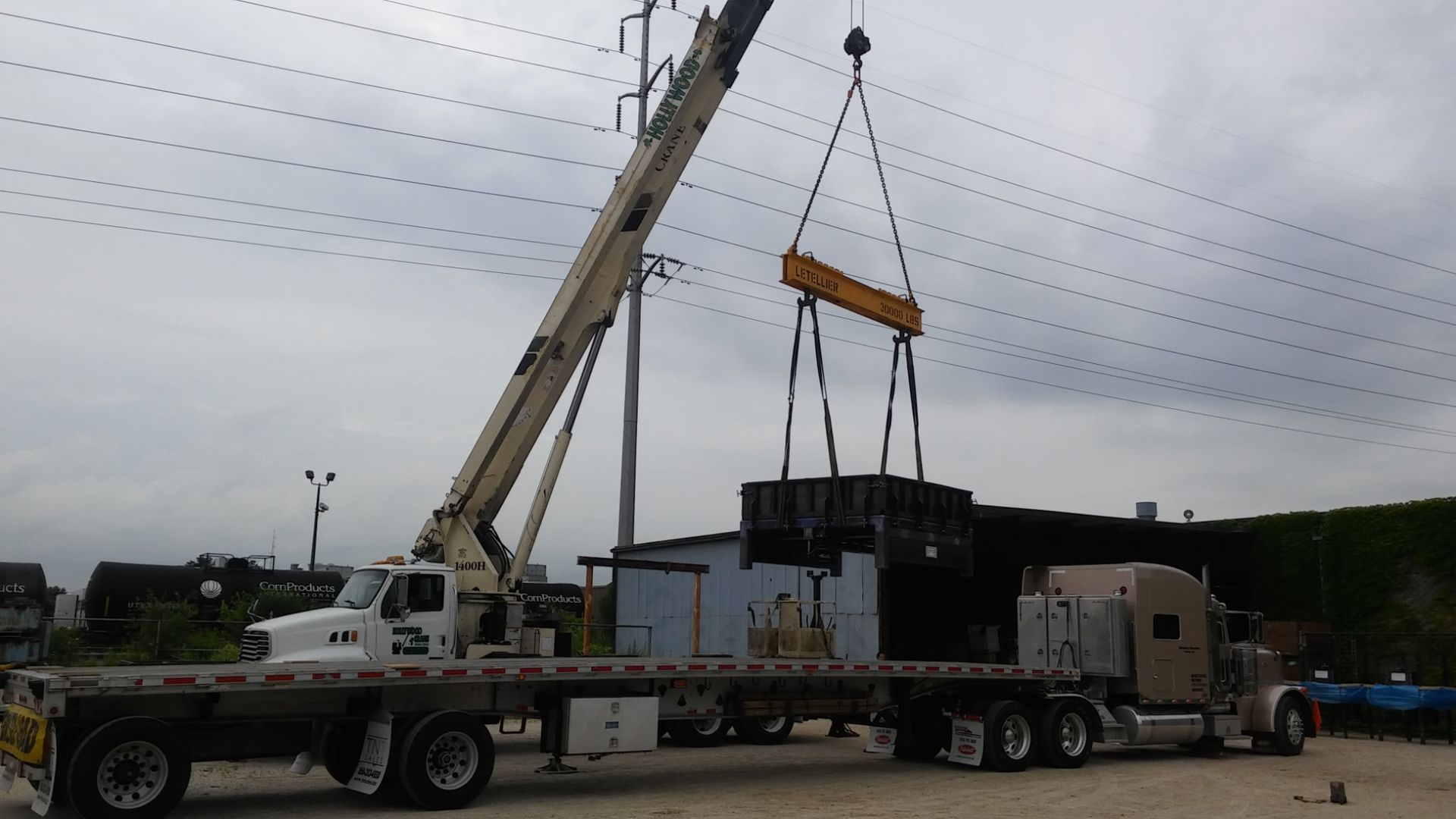 A semi truck with a crane attached to it