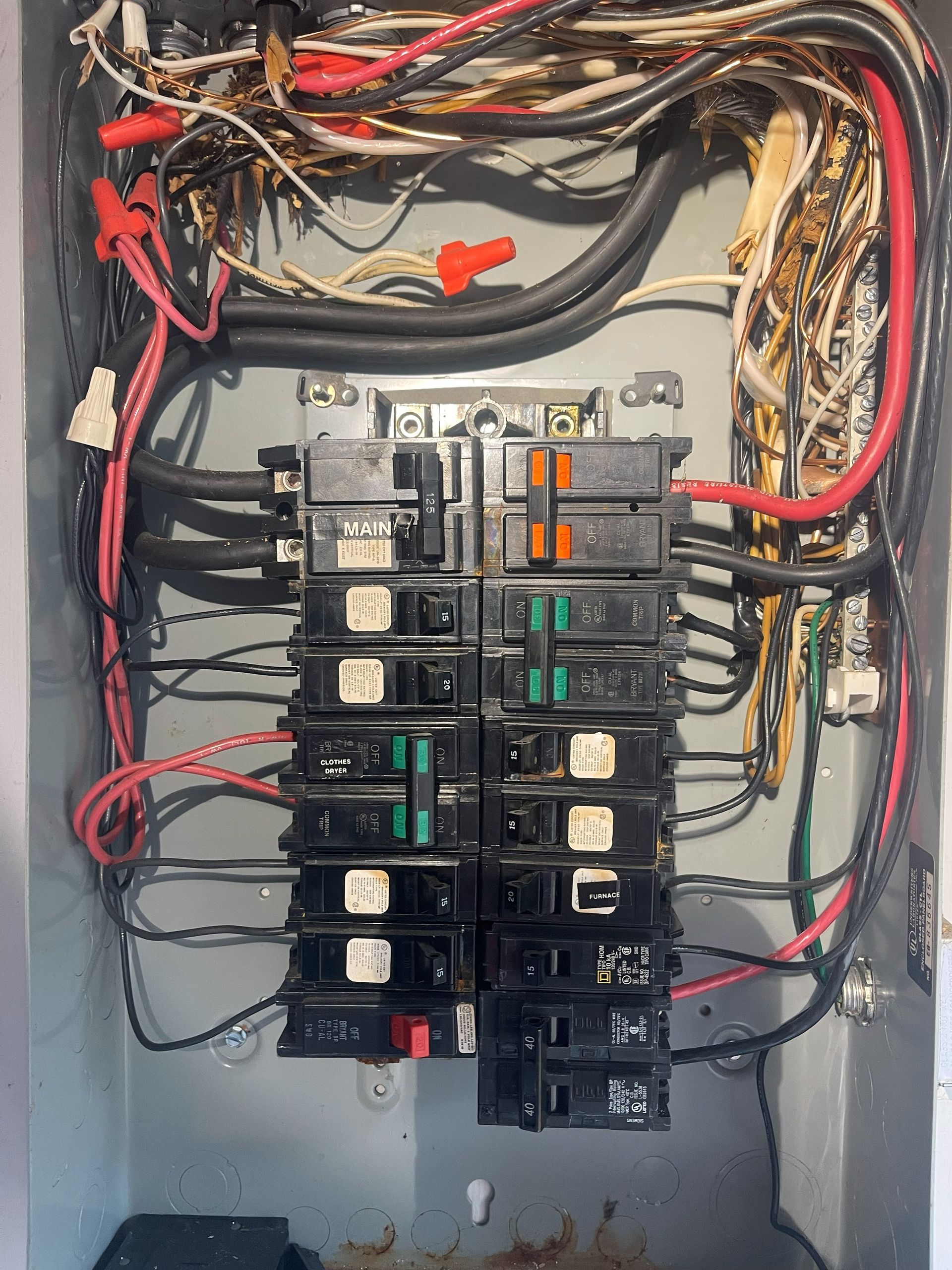 Electrical panel with various wires and circuit breakers.