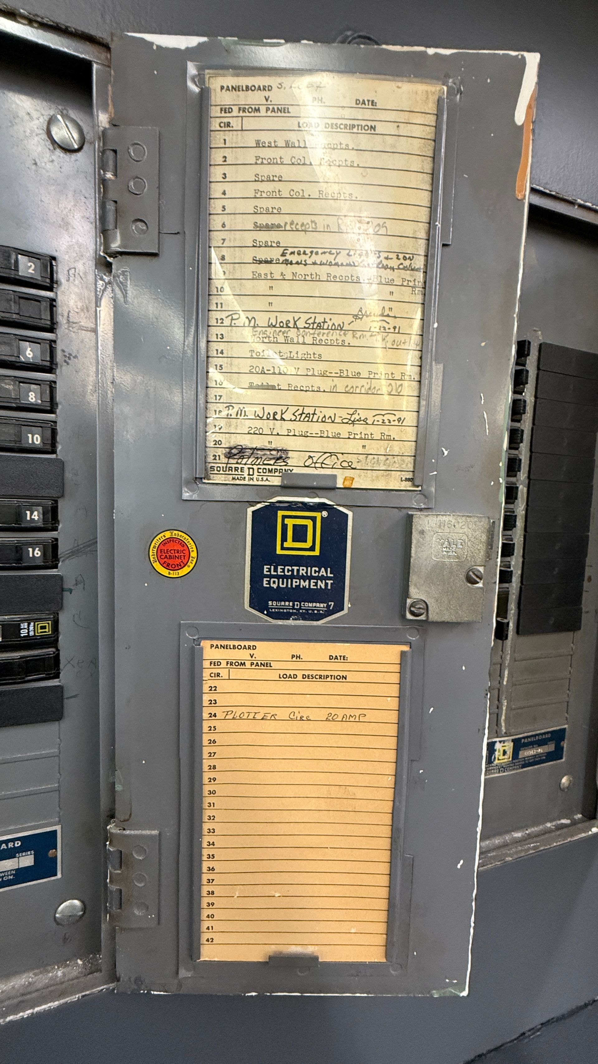 Gray electrical panel with labels, a Square D logo, and a visible circuit diagram.