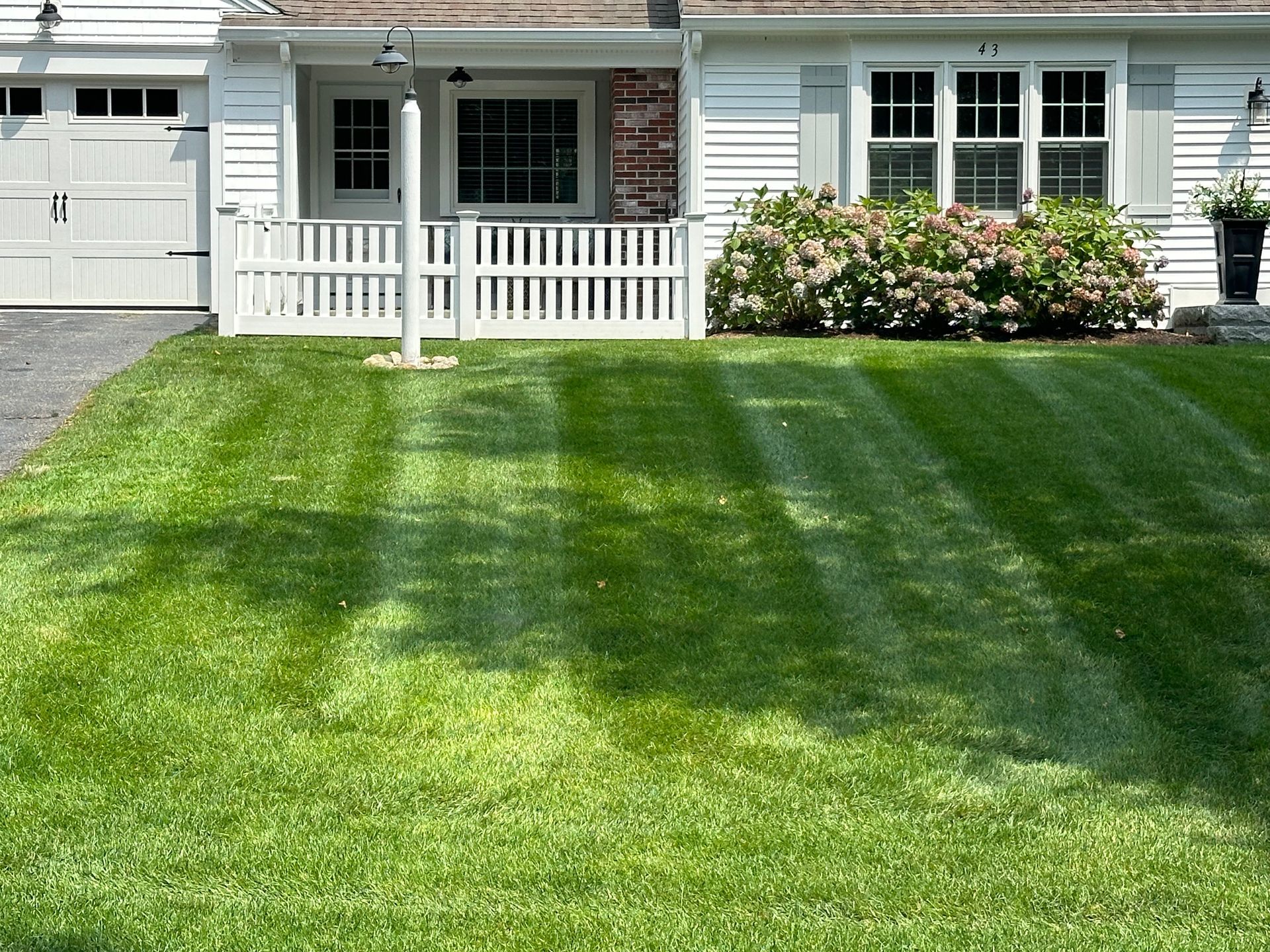 A house with a lush green lawn in front of it