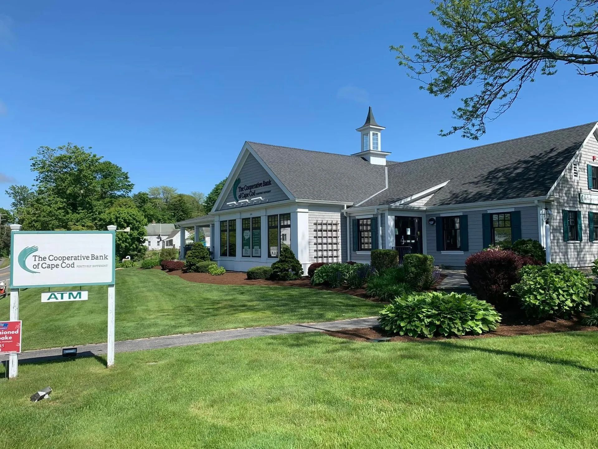 A large white house with a sign in front of it that says park