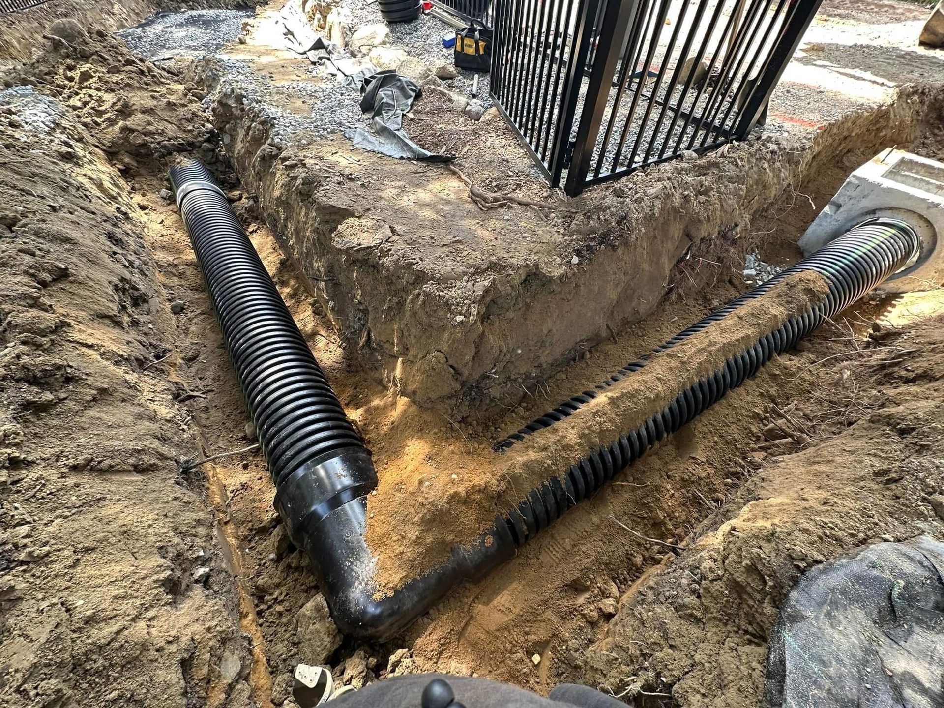 A drain pipe is being installed in the dirt.
