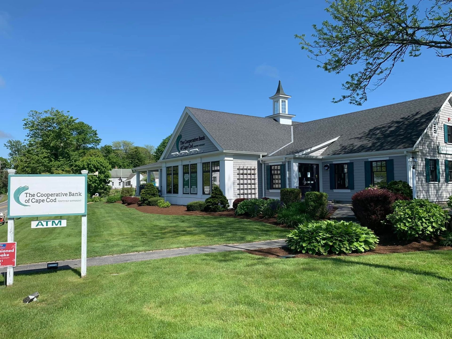 A large white house with a sign in front of it that says parking