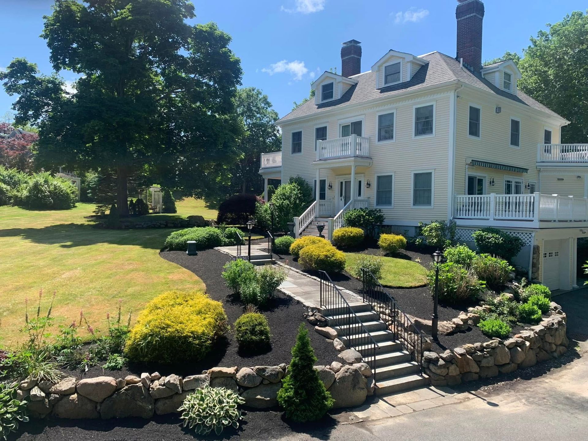 A large white house with stairs leading up to it