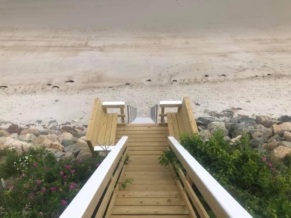 A wooden walkway leading to the beach.
