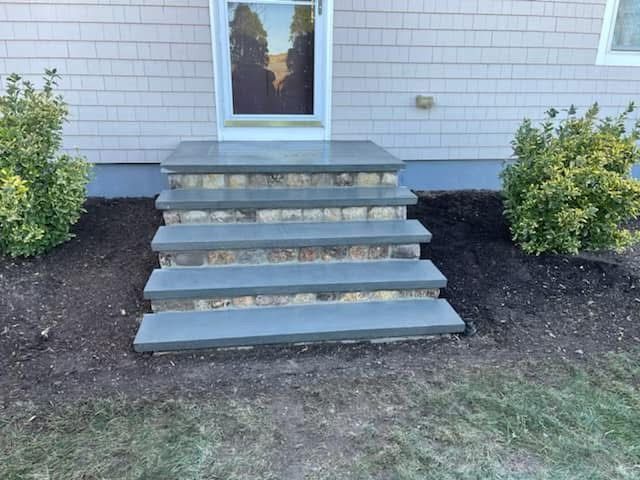 A set of stairs leading up to the front door of a house.