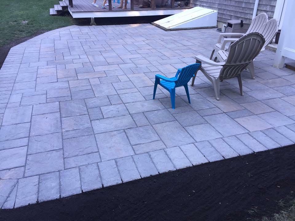 A patio with chairs and a blue chair on it