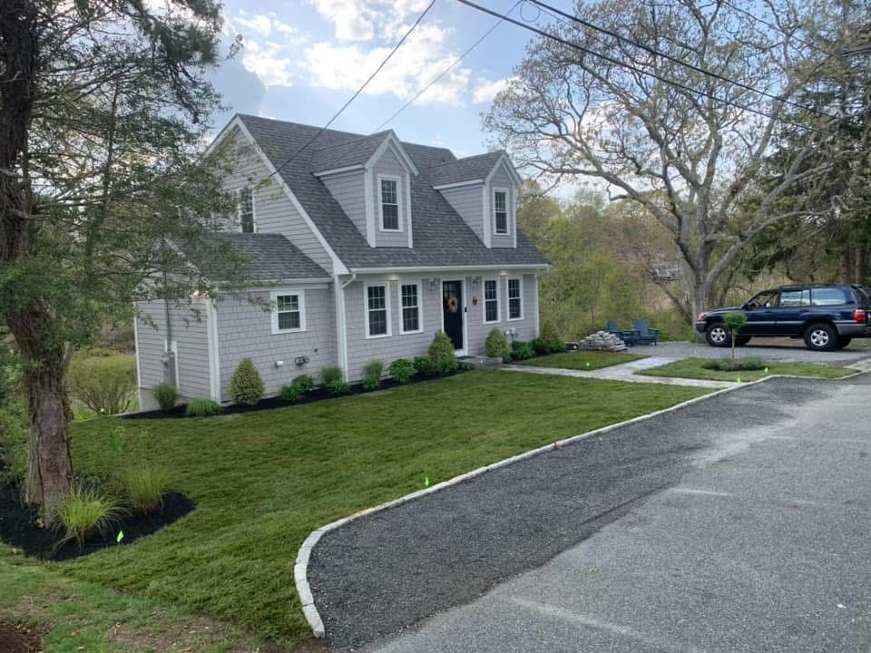A house with a car parked in front of it.