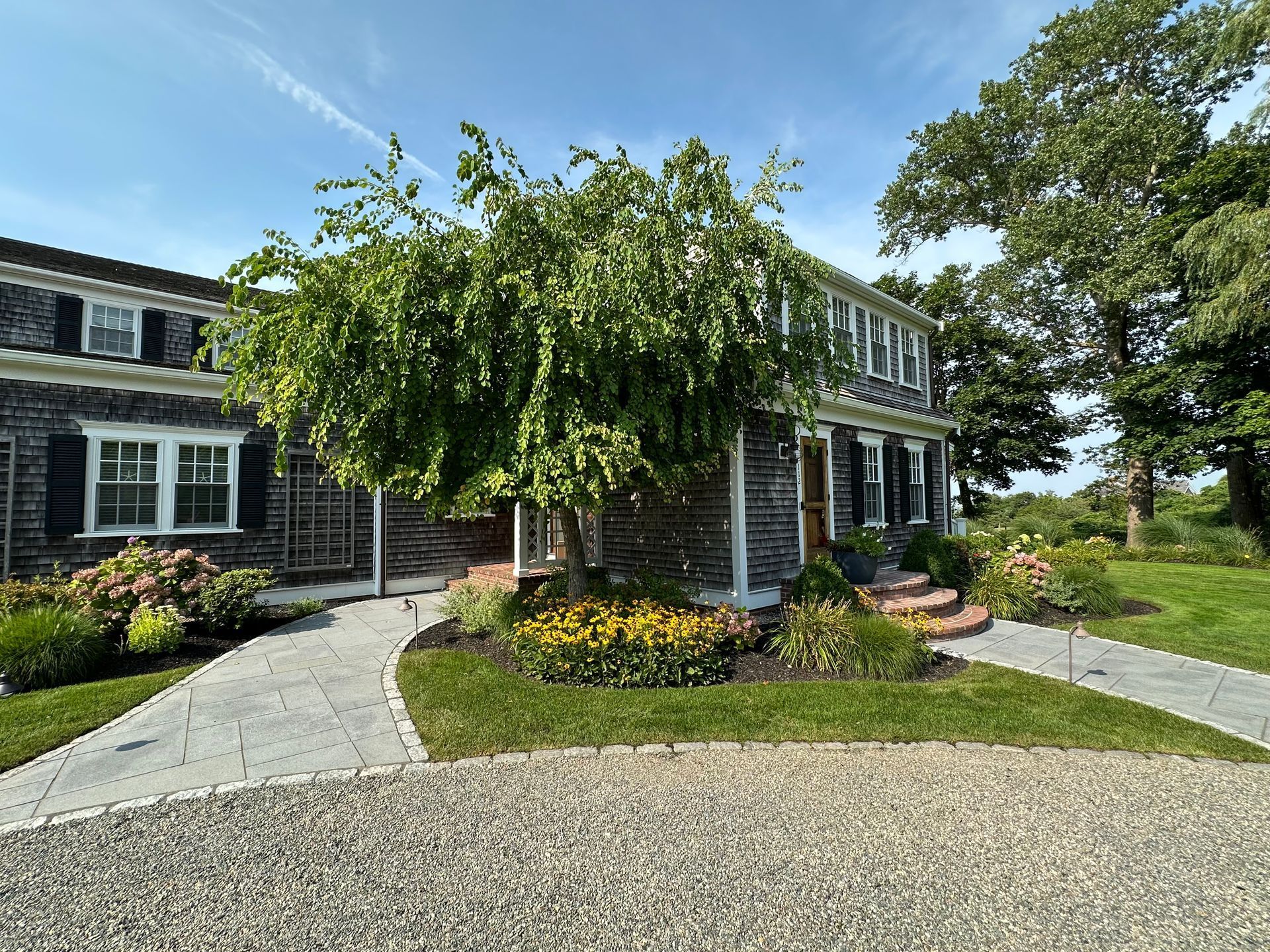 A large house with a tree in front of it