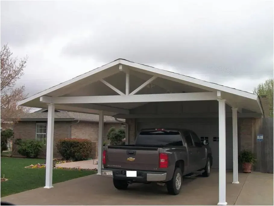 Pickup truck parked under a white carport beside a suburban house