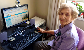 An old woman using a computer