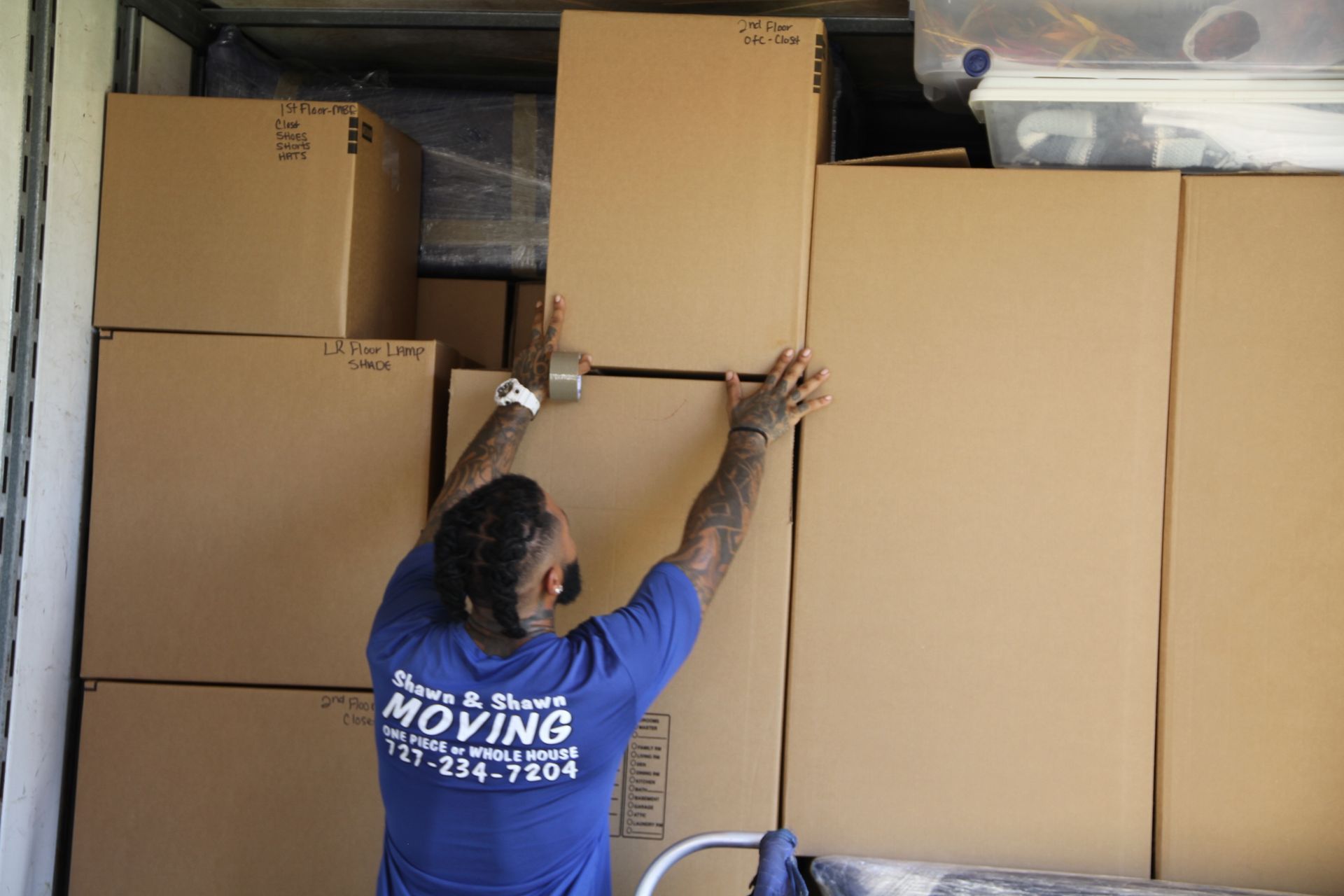 three men moving things to a truck