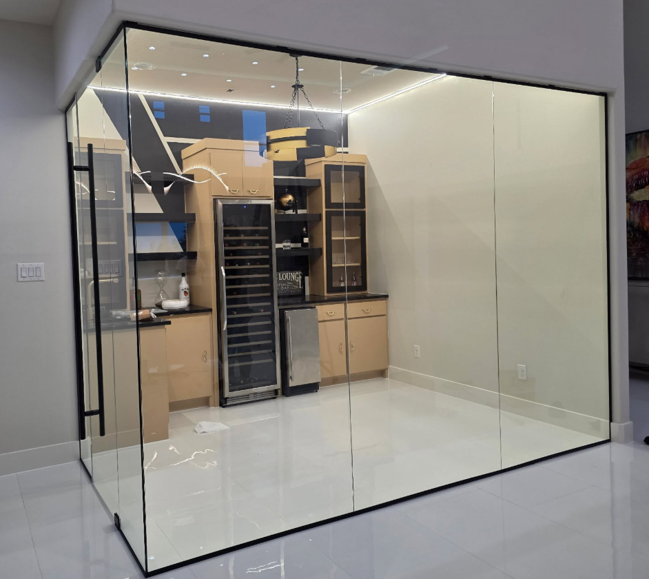 Modern glass-fronted walk-in closet with shelves, cabinets, and LED ceiling lighting