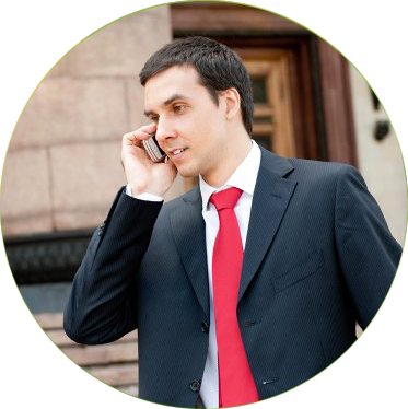 Guy in a black suit answering a phone call