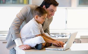 Guy and his child using a computer