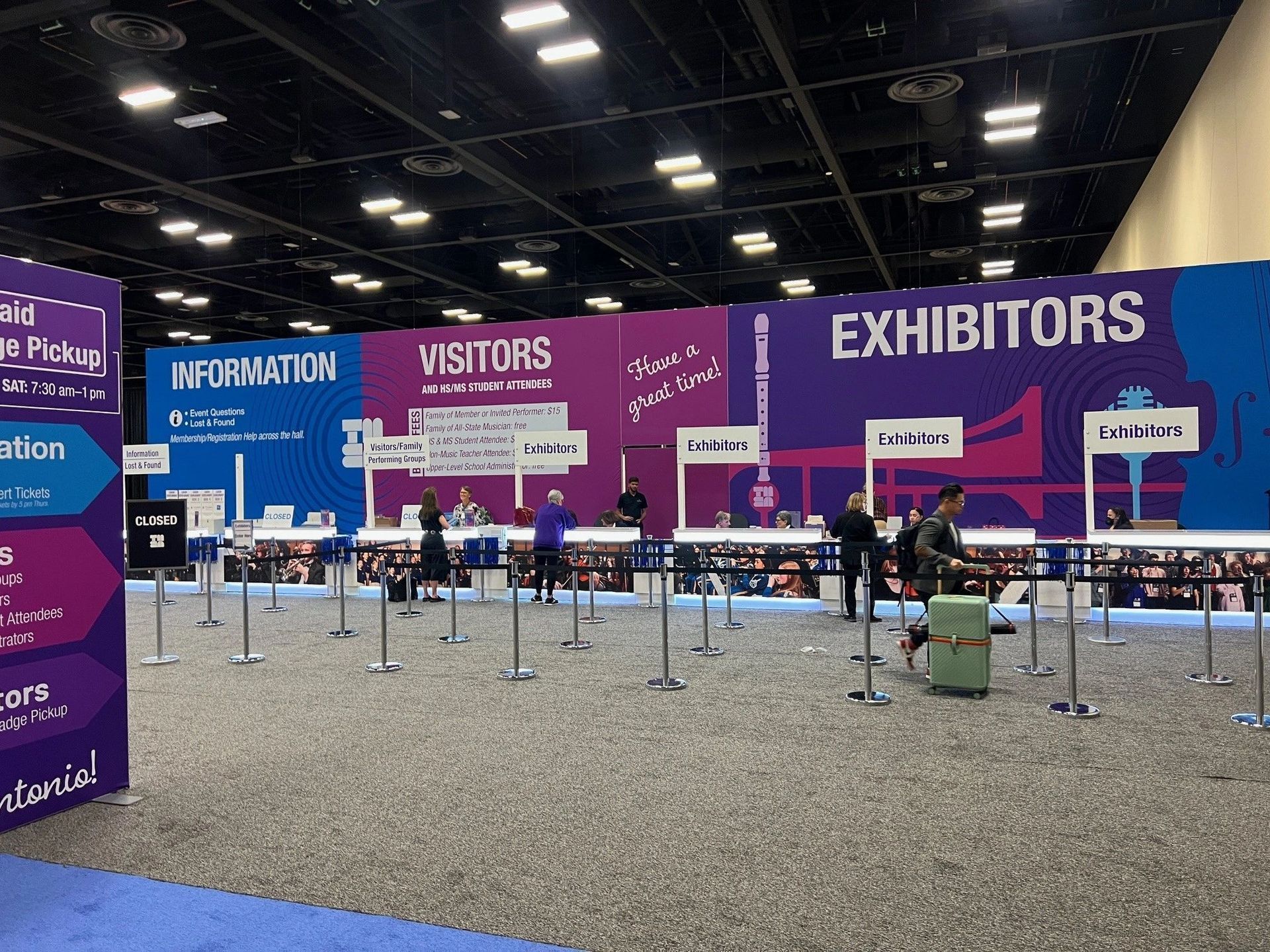 A large purple sign that says exhibitors on it