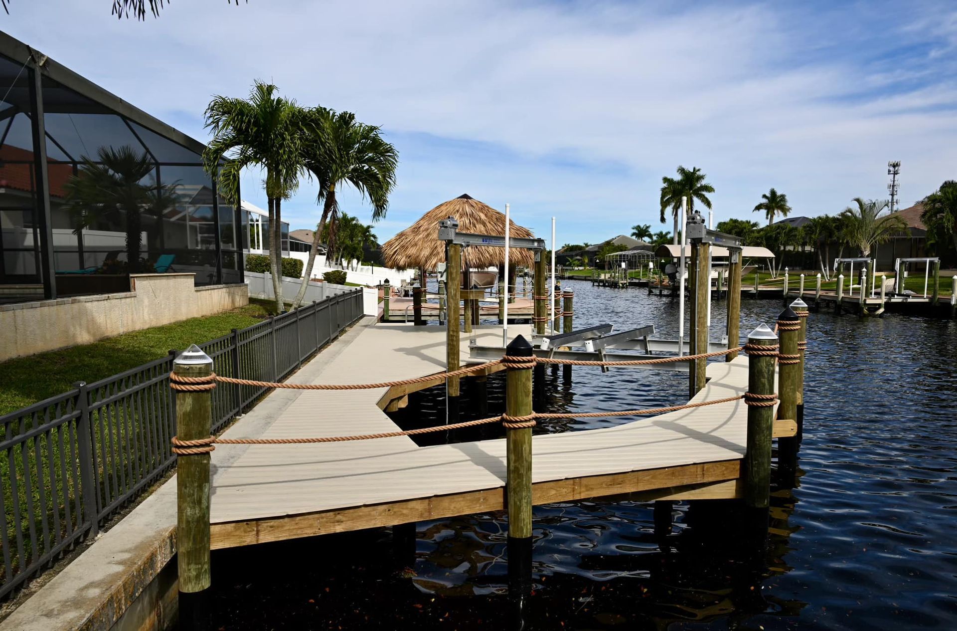 A boat is docked at a dock next to a house
