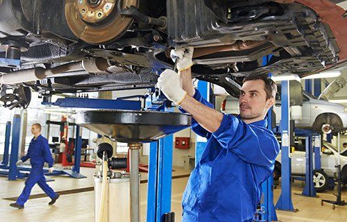 A mechanic changing a car's oil