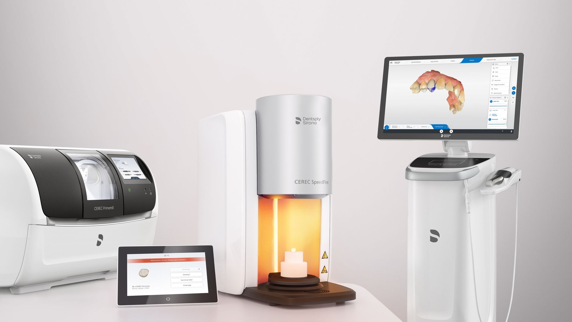 A Dentsply Sirona CEREC dental system including a scanner station, milling unit, and furnace for chairside restorations.