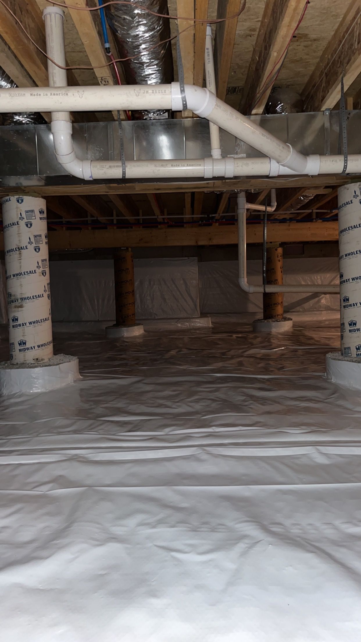 A basement with a lot of pipes coming out of it.