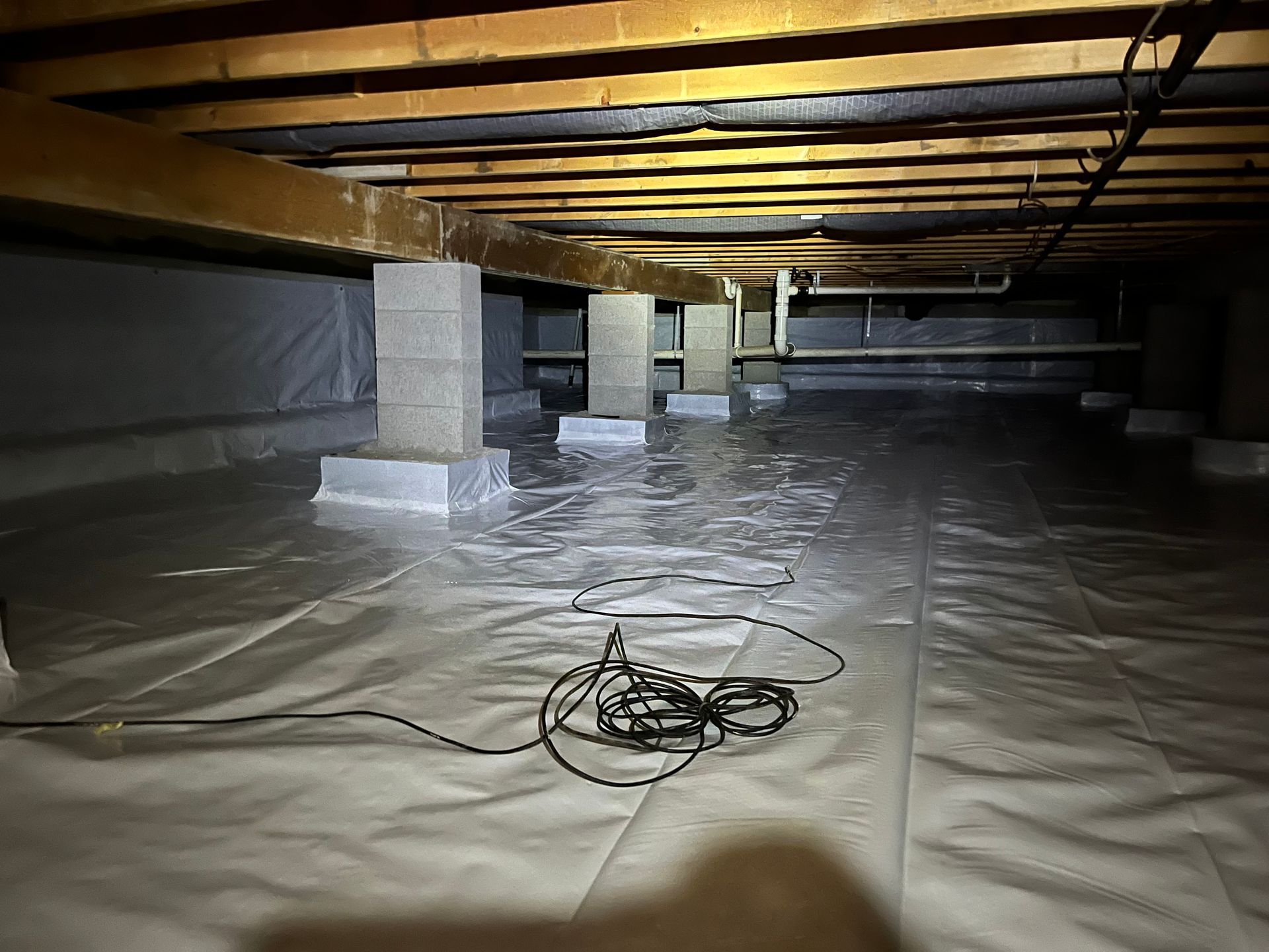 A room with a lot of electrical wires hanging from the ceiling.