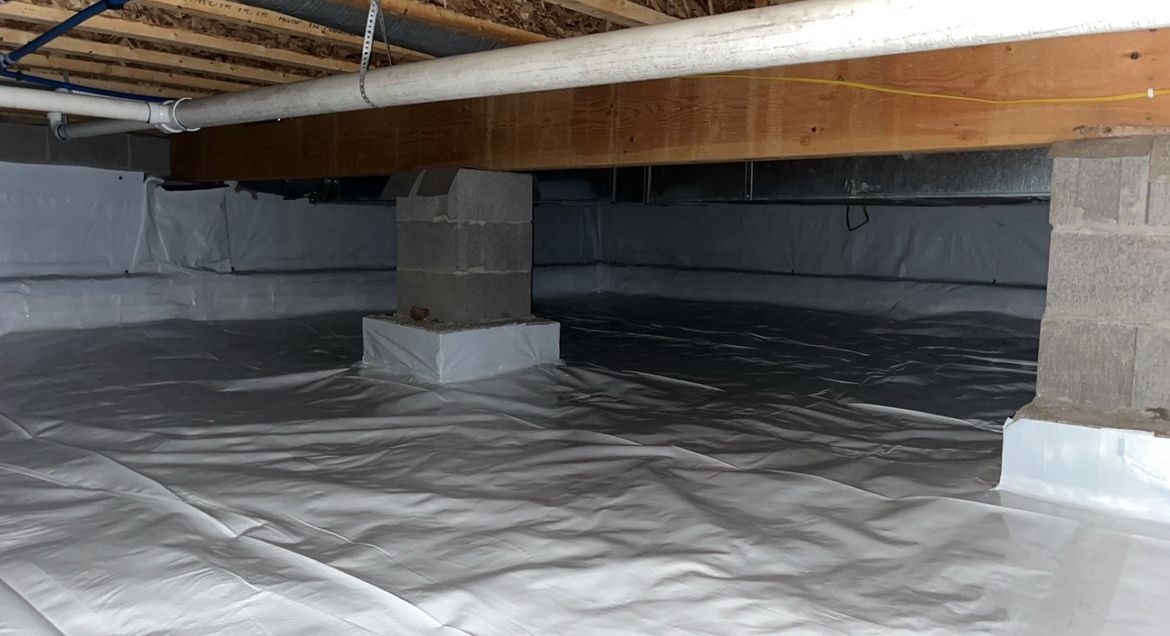 A crawl space with a lot of plastic on the floor.