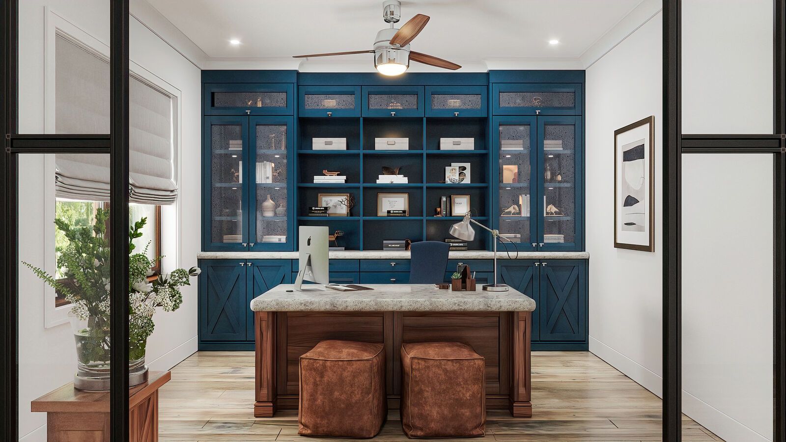 A home office with a blue built-in bookcase and a wooden desk with two brown leather ottomans.