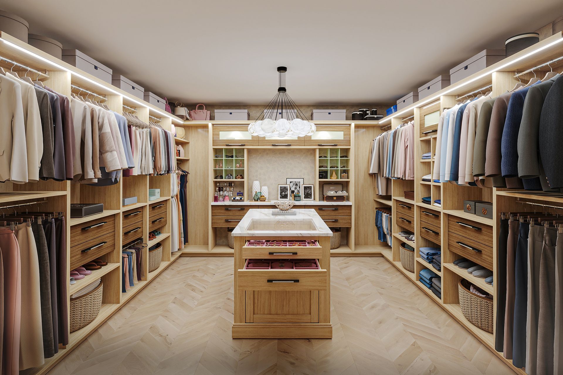Spacious walk-in closet with light wood shelves, drawers, and hanging rods filled with clothes; a central island adds storage and a small sink.