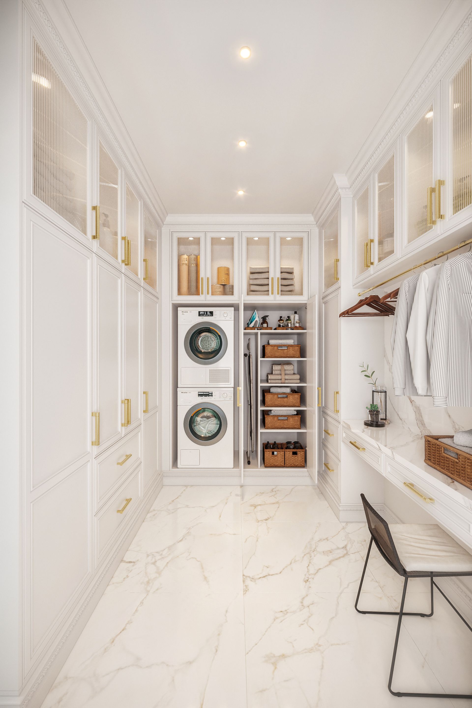 Elegant white laundry room with stacked washer and dryer, custom shelving, and a small desk. Bright, marble floor.